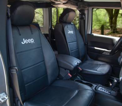 Jeep Black leather car seats with the "Jeep" logo, inside a vehicle, suggesting a comfortable and durable interior.